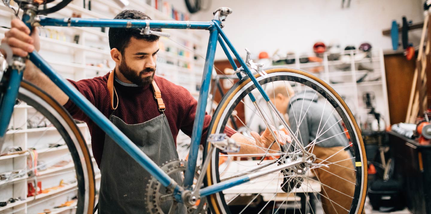 A businessman working on a bike.