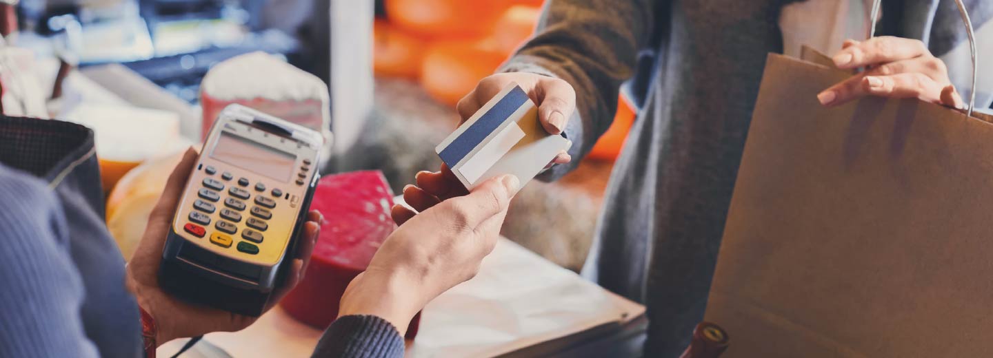 Close up of two people's hands exchanging a credit card.