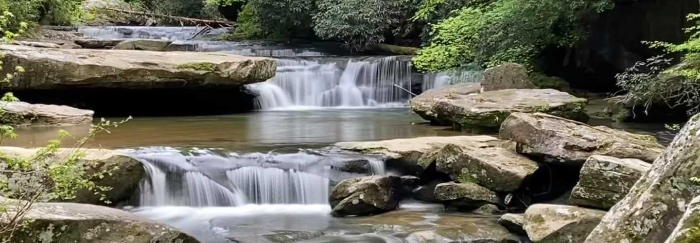 Landscape Photo. Cascade falls in Corbin, Kentucky. Rocky creekbed with two small water falls. Photo taken by Susan Cunigan.