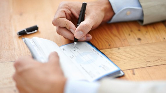 man writing a check