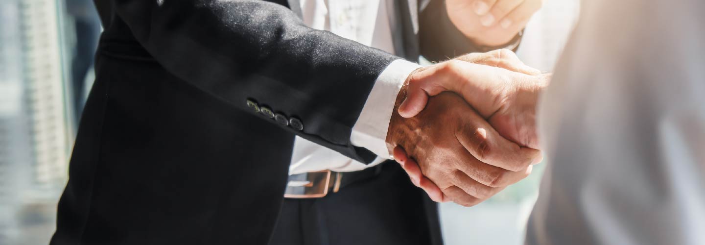 Close up of two people shaking hands.