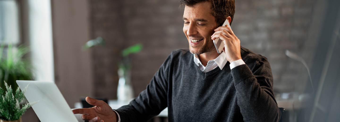 A businessman talking on a cell phone.