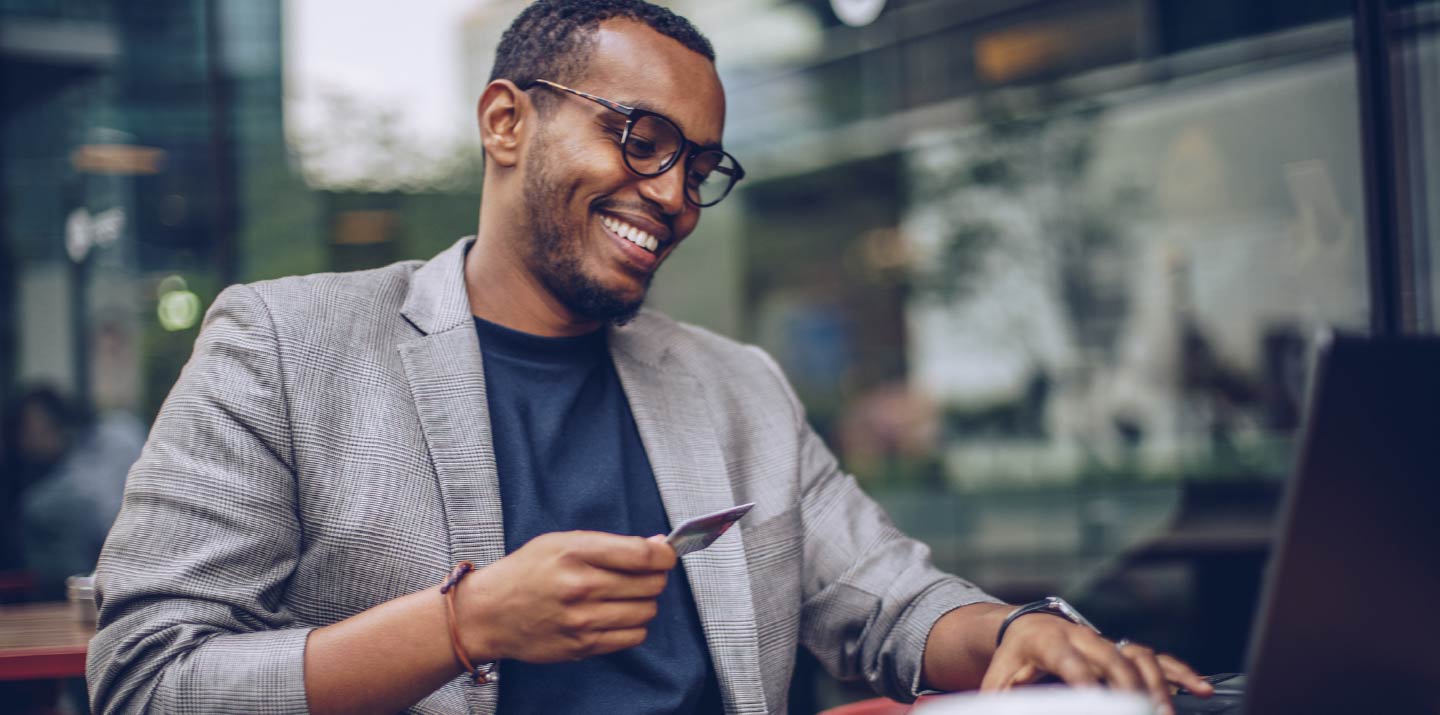 A businessman holding a credit card.