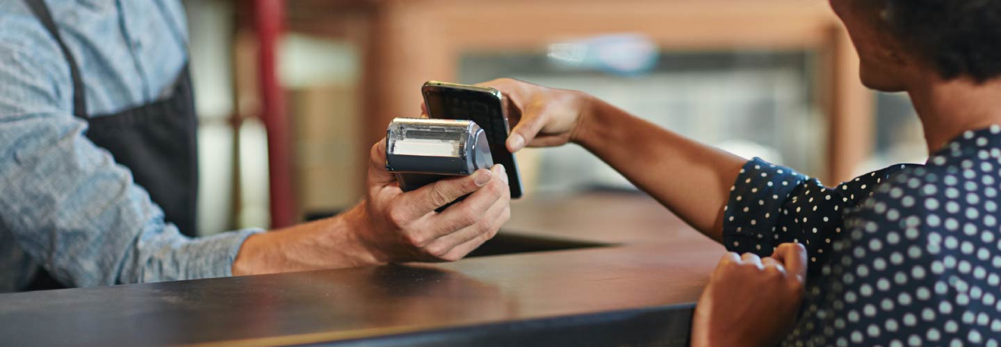 Close up of two people's hands exchanging payment.