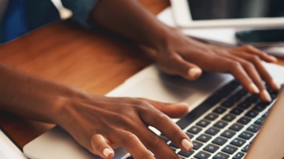 hands typing on a keyboard